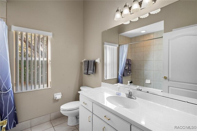 full bath with vanity, baseboards, tile patterned flooring, curtained shower, and toilet