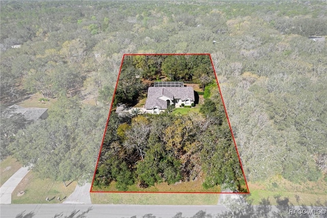 aerial view featuring a wooded view