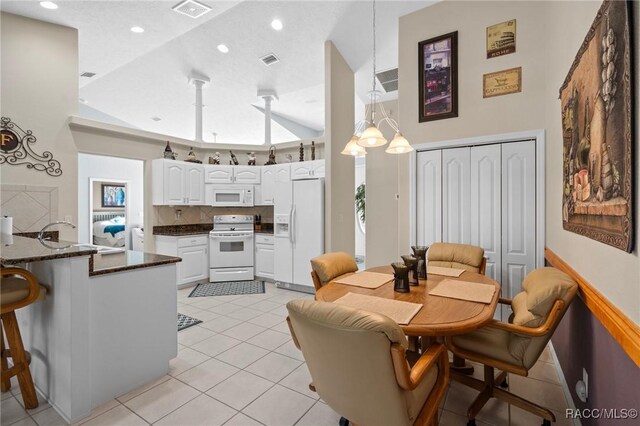 dining space featuring visible vents, recessed lighting, light tile patterned flooring, plenty of natural light, and high vaulted ceiling