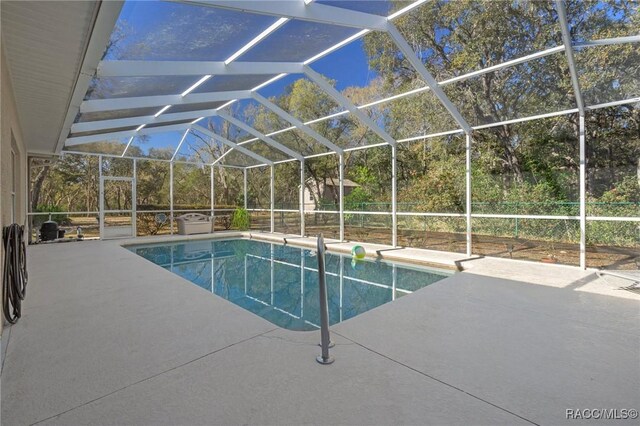 outdoor pool with a patio area and a lanai