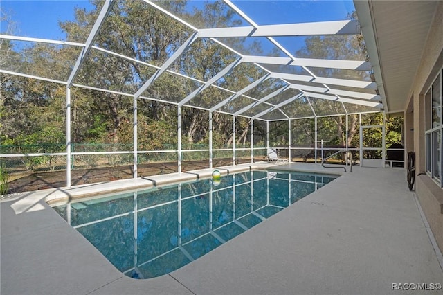 outdoor pool featuring a patio area and a lanai