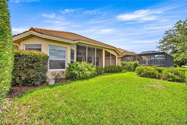 1328 W Diamond Shore Loop, Hernando, FL 34442 - back of house with stucco siding, a lawn, and a tiled roof
