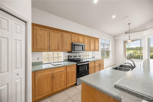 1328 W Diamond Shore Loop, Hernando, FL 34442 - kitchen with stainless steel appliances, vaulted ceiling, pendant lighting, brown cabinetry, and light tile patterned floors