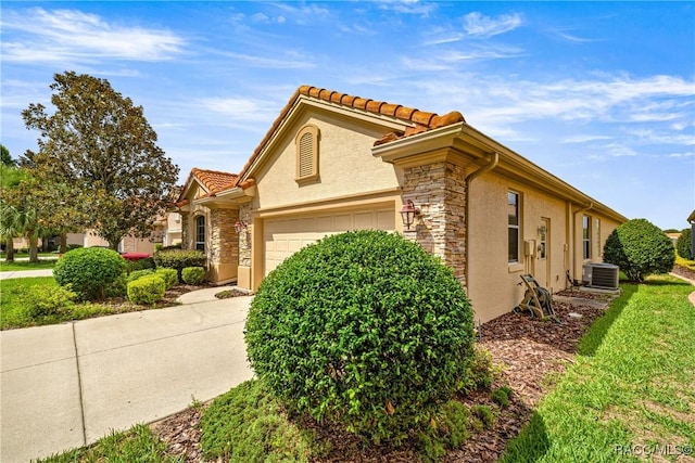 1328 W Diamond Shore Loop, Hernando, FL 34442 - view of property exterior featuring stone siding, an attached garage, stucco siding, and a tiled roof