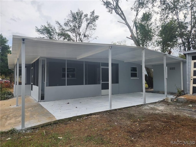 rear view of property featuring a patio