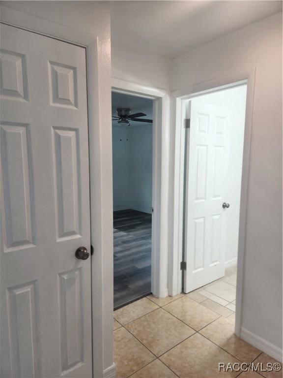 hall with light tile patterned floors