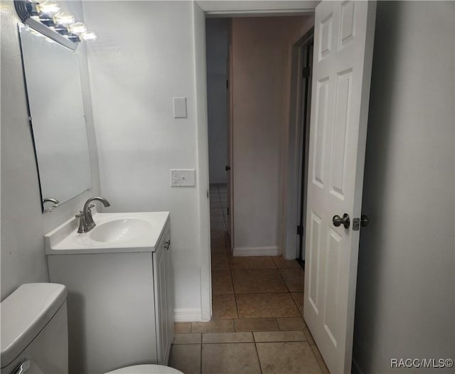 bathroom with tile patterned floors, vanity, and toilet