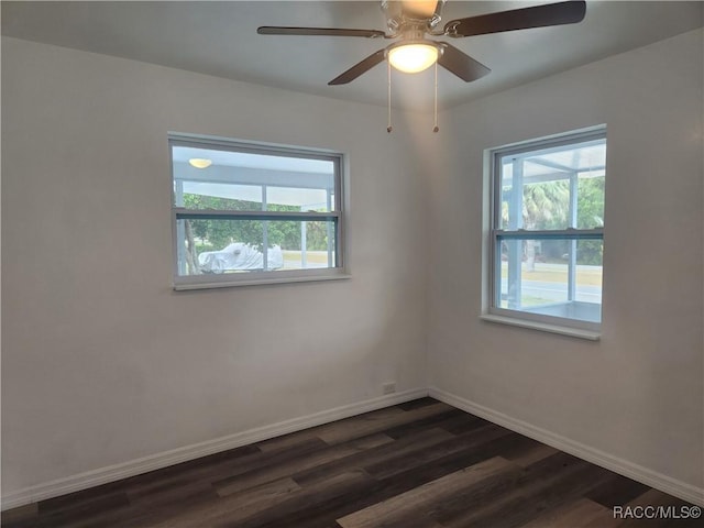 spare room with ceiling fan and dark wood-type flooring