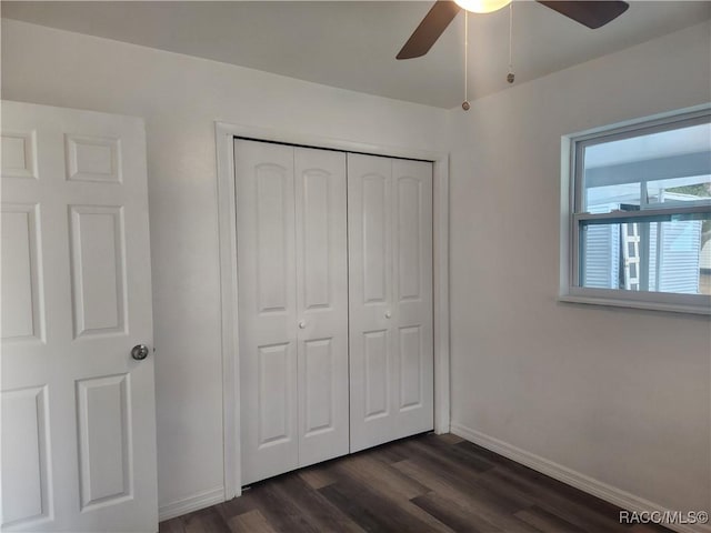 unfurnished bedroom featuring ceiling fan, a closet, and dark hardwood / wood-style floors