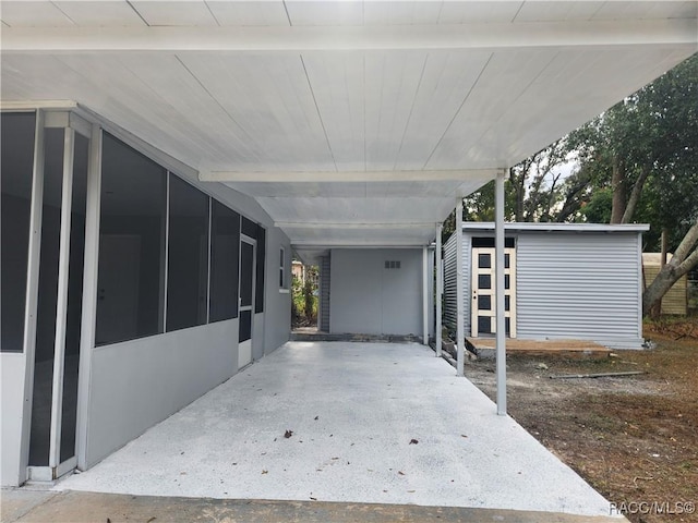 exterior space featuring a carport and a sunroom