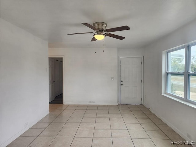 unfurnished room featuring ceiling fan and light tile patterned floors