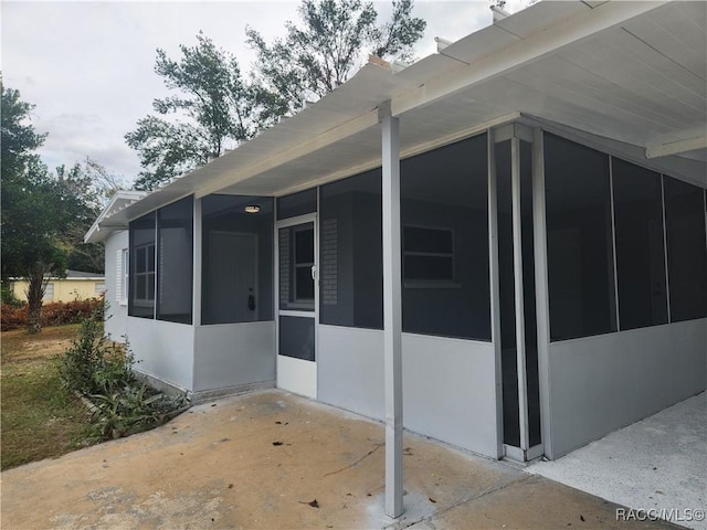 view of side of home featuring a sunroom