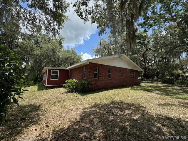 view of home's exterior with a yard