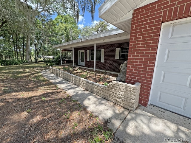 exterior space featuring a porch and a garage