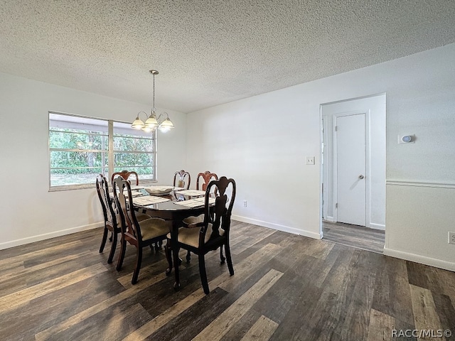 dining room with a textured ceiling, dark wood-type flooring, and a notable chandelier