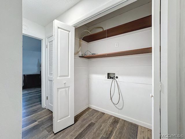 washroom with washer hookup, dark hardwood / wood-style flooring, and a textured ceiling