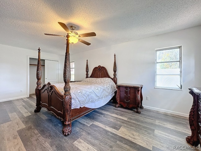 bedroom with ceiling fan, a closet, a textured ceiling, and dark wood-type flooring