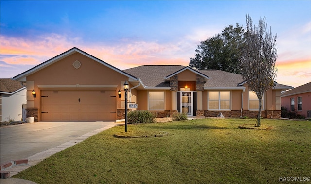 view of front of property featuring a garage and a yard