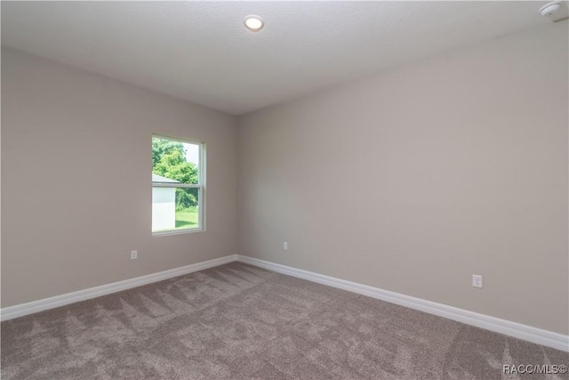 9276 N Alpinia Dr, Citrus Springs, FL 34434 - spare room with carpet floors, a smoke detector, and baseboards