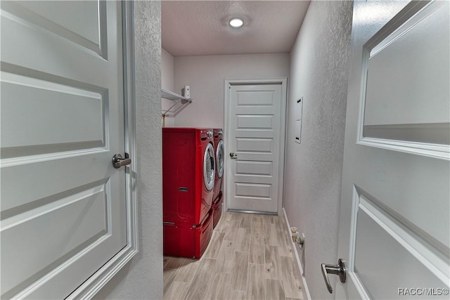 laundry area featuring independent washer and dryer, a textured ceiling, and light wood-type flooring