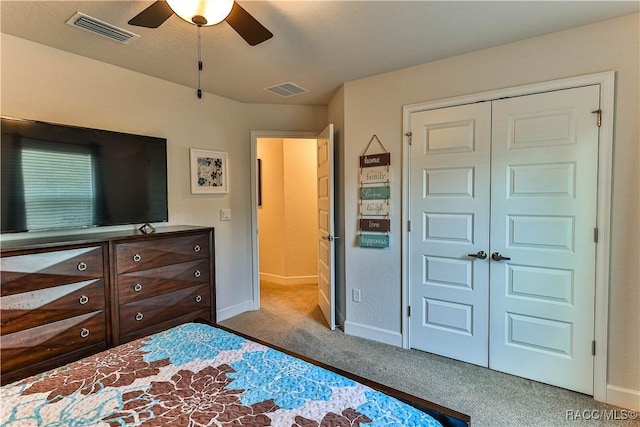 bedroom with light carpet, ceiling fan, and a closet