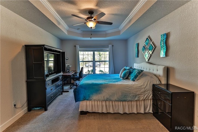 carpeted bedroom with ceiling fan, ornamental molding, a raised ceiling, and a textured ceiling