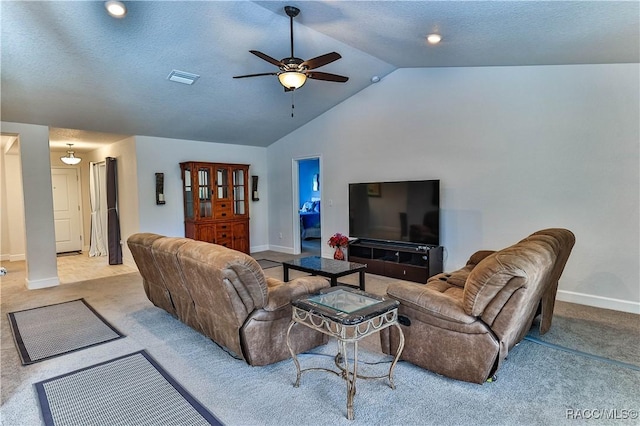 living room featuring light carpet, a textured ceiling, lofted ceiling, and ceiling fan