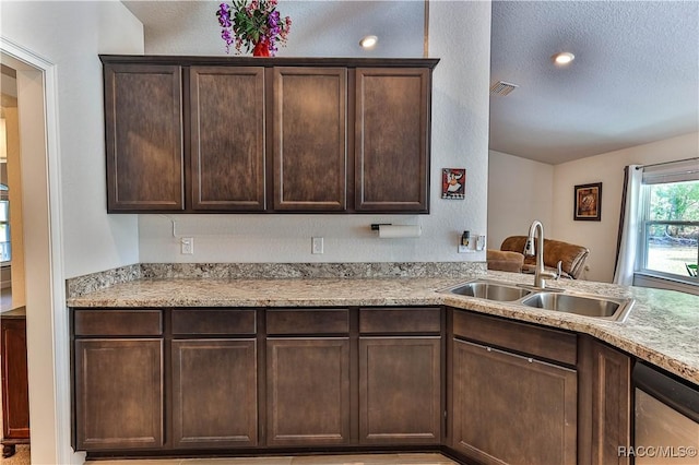 kitchen featuring dark brown cabinetry, sink, a textured ceiling, and dishwasher