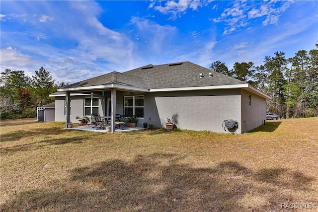 back of house with a yard and a patio area