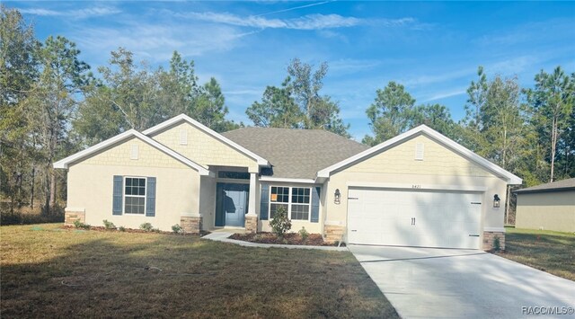 view of front facade featuring a garage and a front lawn