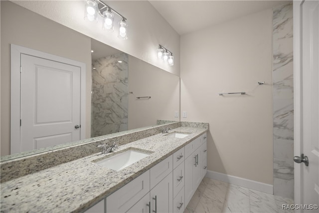 bathroom featuring tiled shower and vanity