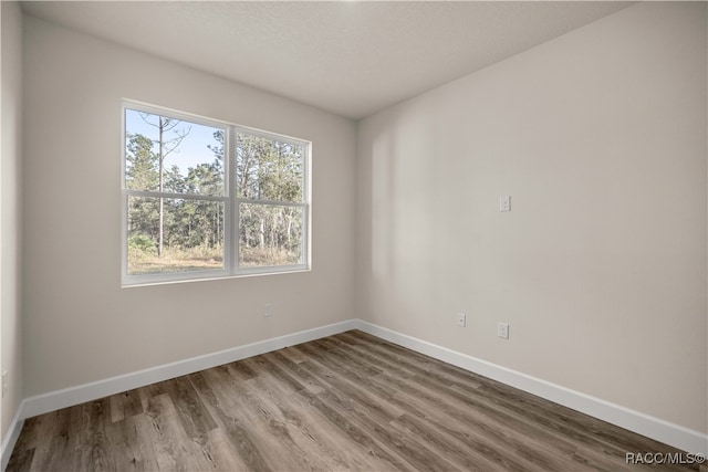 unfurnished room featuring wood-type flooring