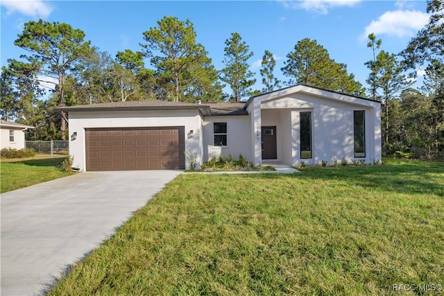 view of front of property featuring a garage and a front yard