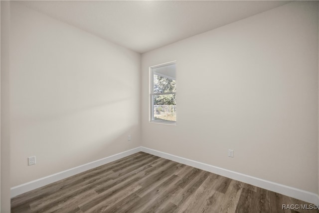 empty room with hardwood / wood-style floors