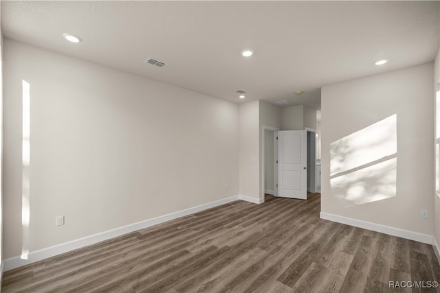 unfurnished room with dark hardwood / wood-style flooring