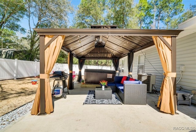 view of patio / terrace featuring outdoor lounge area, a gazebo, a hot tub, and central air condition unit