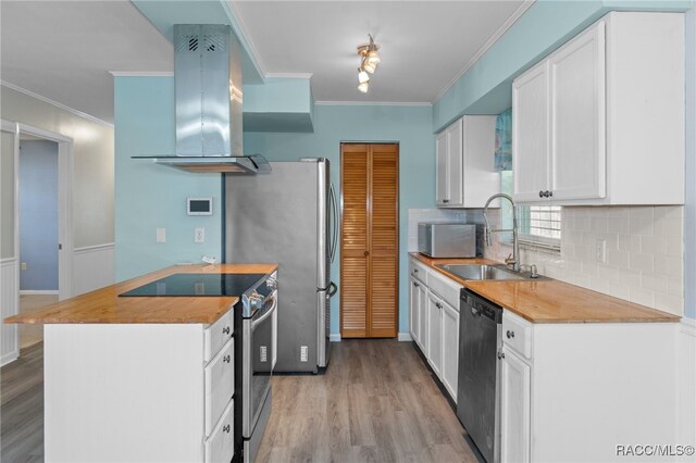 kitchen featuring white cabinetry, sink, stainless steel appliances, light hardwood / wood-style flooring, and extractor fan