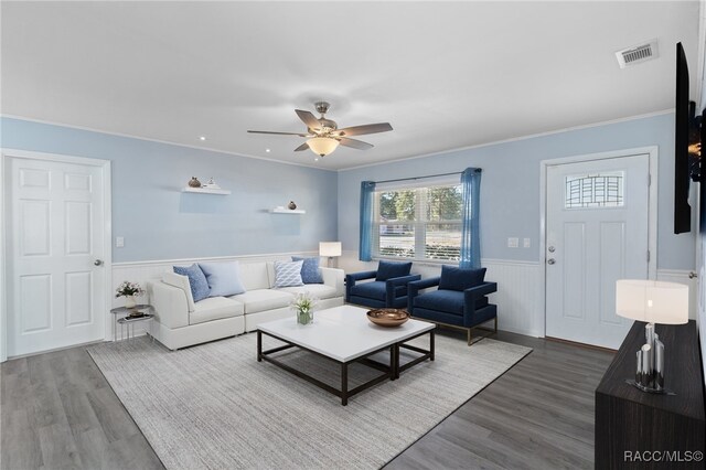 living room with wood-type flooring, ceiling fan, and crown molding