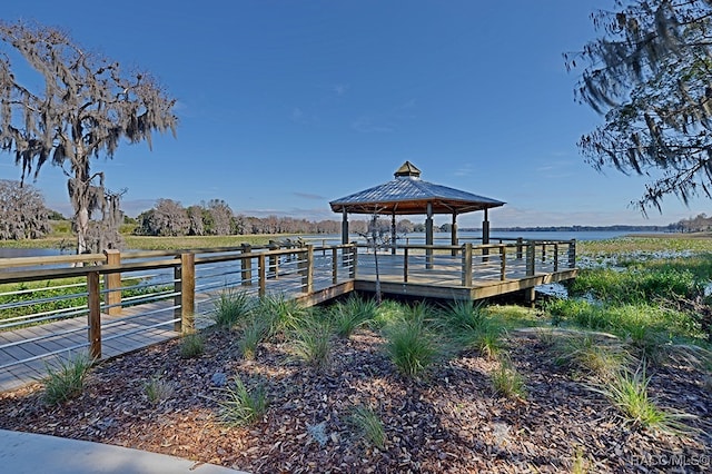 dock area featuring a gazebo, a water view, and a rural view