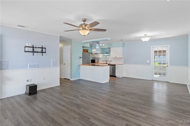 unfurnished living room featuring crown molding, ceiling fan, and hardwood / wood-style flooring