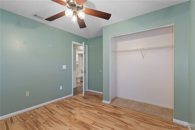 unfurnished bedroom with ceiling fan, light hardwood / wood-style floors, and a closet