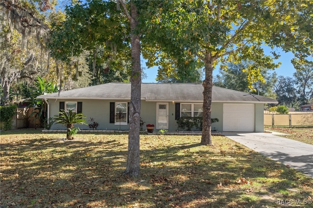 single story home featuring a front yard and a garage