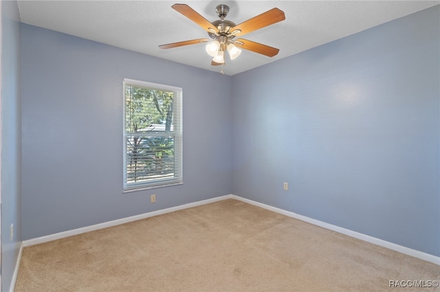 empty room with light carpet and ceiling fan