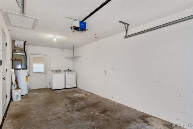 garage featuring washer and dryer, a garage door opener, and water heater