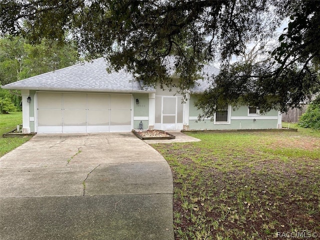 single story home featuring a front yard and a garage