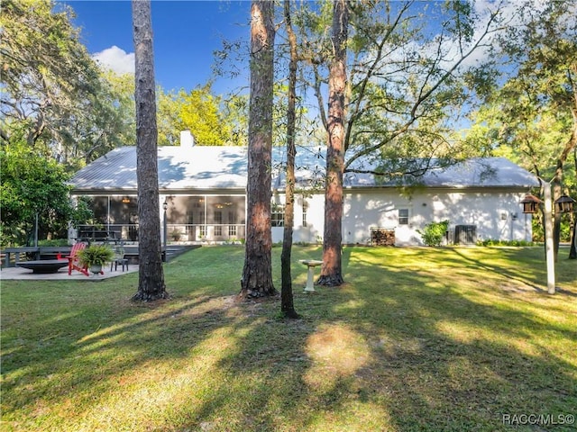 view of yard with a patio area and a sunroom