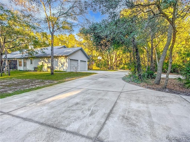 view of home's exterior with a garage and a yard