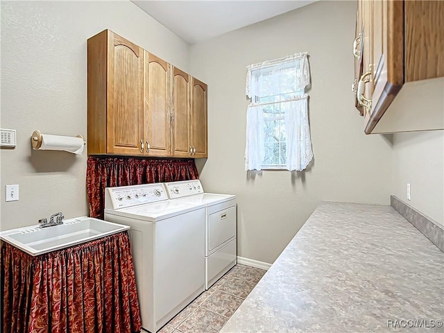 washroom with sink, light tile patterned flooring, cabinets, and independent washer and dryer