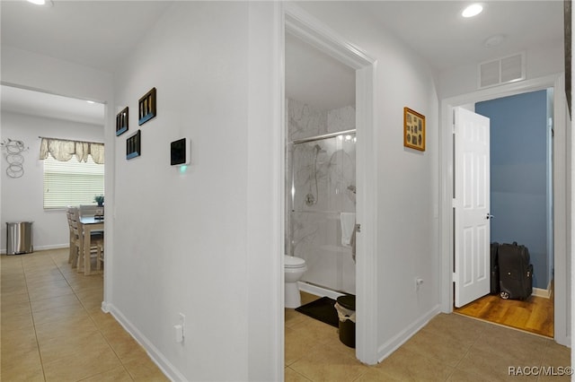 corridor featuring light tile patterned flooring