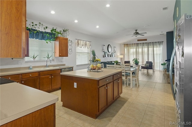 kitchen with a center island, appliances with stainless steel finishes, plenty of natural light, and sink